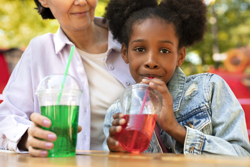 photo of a mum and daughter drinking from a juice pouch
